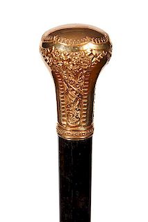 180. Gold Dress Cane- Ca. 1900- A signed Simmons ornate gold-filled dress cane with three panels ready for engraving, ebony s