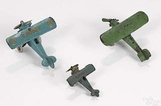Three small cast iron airplanes, to include two Hubley Lindy airplanes