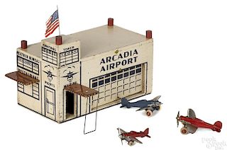 Arcade painted wood Arcadia Airport terminal with tin awnings and a flag