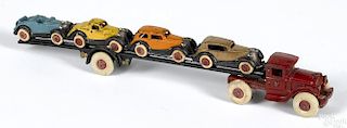 Hubley cast iron car carrier with four cars, a scarce example with a one-piece cast trailer