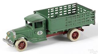 Arcade cast iron International low side stake truck with rubber tired spoke wheels, 12'' l.