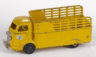 Arcade cast iron International cab over engine dump truck with a nickel-plated grill and bumper