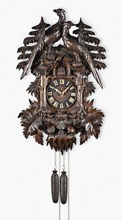 Black Forest hanging cuckoo clock with impressive hand carved rustic forest scene