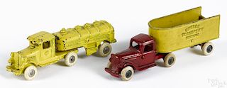 Two cast iron tandem trucks, to include an Arcade Transport Service, 7 1/4'' l.