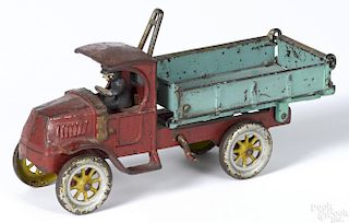 Kenton cast iron dump truck with a painted driver, 11'' l.