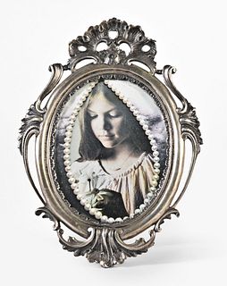 A small oval silver photo frame marked M. Buccellati Italy