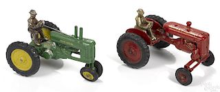 Two Arcade cast iron farm tractors with nickel-plated drivers, to include a John Deere, 7 1/2'' l