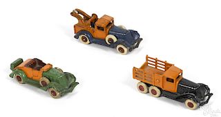 Three Hubley cast iron take-apart vehicles, to include a wrecker, a twin rear axle stake truck
