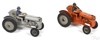Two Arcade Ford 9n cast iron tractors, gray and orange, with painted drivers, 6 1/2'' l.