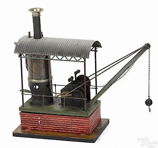 Bing live steam crane, with a faux brick and wood base and a corrugated tin roof
