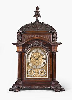 A very decorative carved mahogany English bracket clock by Elliott London
