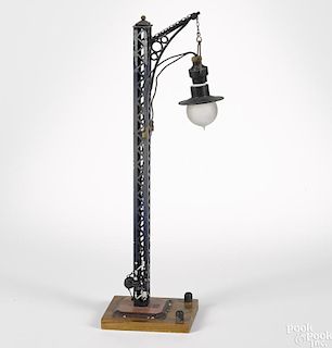 Bing painted tin electric trestle railroad lamp with a hand crank and wood base, 18 1/2'' h.