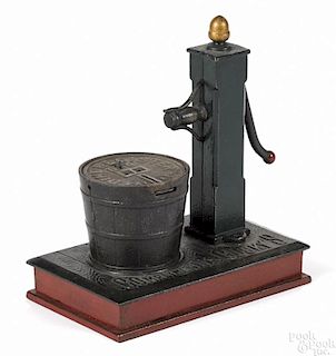 Cast iron Pump and Bucket mechanical bank, inscribed on base Compliments of Gusky's.