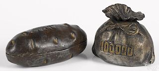 Two cast iron still banks, to include a 100,000 money bag, 3 1/4'' h. and a potato, 5 1/2'' l.
