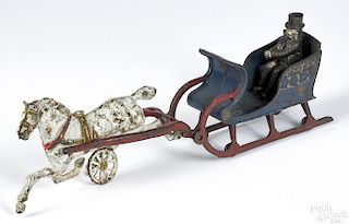 Scarce Dent cast iron one horse sleigh with ornate gold embossing and the original driver