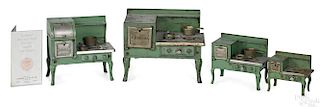 Four Kenton cast iron Universal stoves with miscellaneous pots and pans, tallest - 7 1/4''.