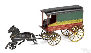 Harris cast iron horse drawn City Delivery closed wagon with the original driver, 15'' l.