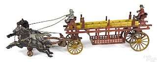 Harris cast iron horse drawn ladder wagon with wood ladders and drivers, 27'' l.