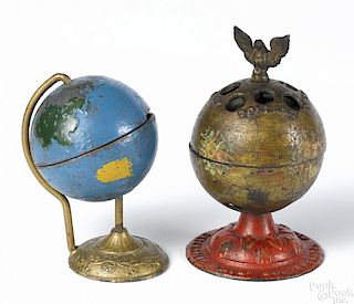 Two cast iron globe still banks, to include an Enterprise with an eagle finial, 5 1/2'' h.