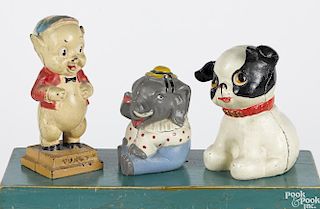 Three Hubley cast iron still banks, to include a Porky pig, a seated elephant, and a seated pup