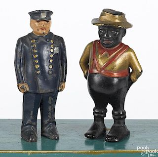 Two cast iron still banks, to include an Arcade policeman, 5 1/2'' h.