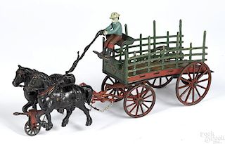 Large Pratt & Letchworth cast iron horse drawn dray wagon with a driver, 17'' l.
