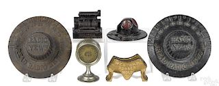 Six cast iron news and advertising paperweights, to include two Read Radio News dials