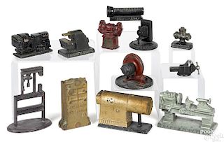 Twelve cast iron advertising paperweights and novelties, to include Peerless radiator