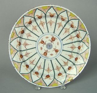 Dutch delft charger, ca. 1735, with green, red, an