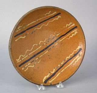 Pennsylvania redware pie plate, early 19th c., wit