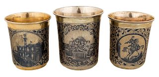 A GROUP OF THREE GILT SILVER AND NIELLO TUMBLERS, VARIOUS MAKERS, MOSCOW, 1845-1847