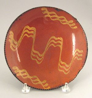 Redware pie plate, 19th c., with yellow slip decor