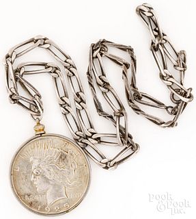 Silver necklace with Peace silver dollar pendant