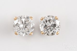 Pair of 14K yellow gold diamond stud earrings