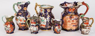 Seven ironstone pitchers, creamers and a syrup jug