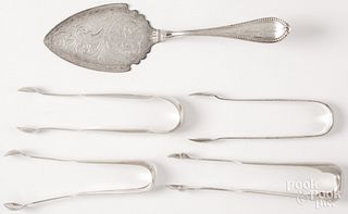 Four coin silver sugar tongs and a serving slice