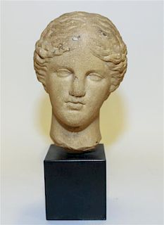A Roman Style Stone Head of a Woman Height overall 10 1/2 inches.