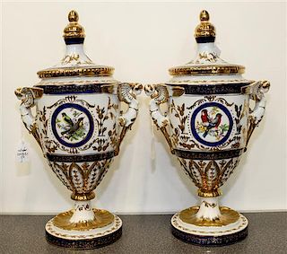* A Pair of Limoges Polychrome and Gilt Decorated Porcelain Covered Urns height 16 1/2 inches.