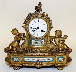 A French Gilt Metal and Sevres Style Porcelain Clock, Pearce & Sons Width 12 3/4 inches.