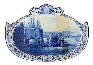 * A Delft Ceramic Plaque, 19TH/20TH CENTURY, of shaped, oval form, depicting an equestrian scene.