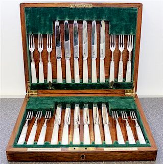 * An English Mother-of-Pearl Handled Silver Fruit Service, Goldsmiths & Silversmiths Co., London, comprising: 12 knives 12 fo