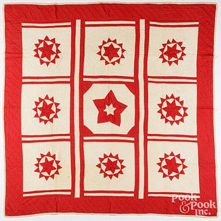 Red and white sunburst patchwork quilt