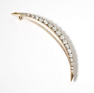 A Victorian diamond and gold crescent brooch