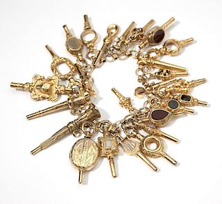 A gold bracelet with antique watch fob charms