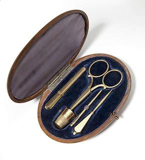 A gold sewing kit in fitted box