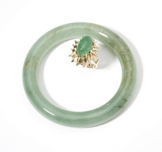 A  jade bangle with an emerald and gold ring