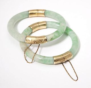A pair of two jade and gold hinged bangles