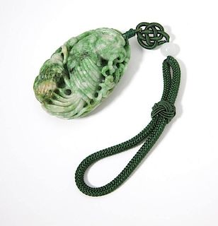 A carved jadeite toggle with a parrot motif
