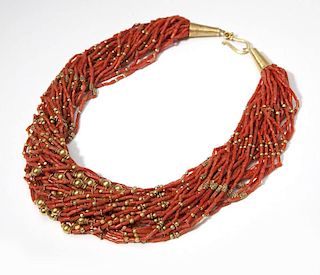 A coral and gold beaded torsade necklace