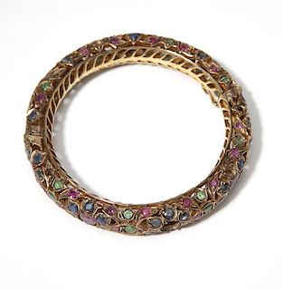 A gem and low-karat gold Indian bangle